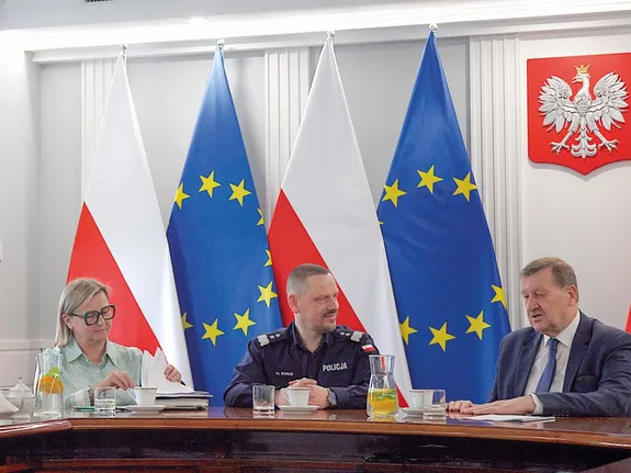 policjanci siedzą przy dłuhoim stole