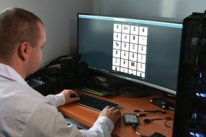 człowiek pracujący przy komputerze nad dowodem cyfrowym