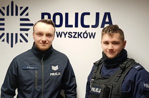 policjanci w radiowozach i obok nich. W budynkach i obok nich. bohaterowie materiału