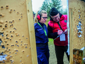 Policjantka z jurorem zliczają wyniki strzelania.