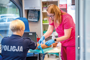 policjantka i pielęgniarka w sali pobierania krwi