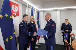 policjant z materiału ze statuetką i podczas wręczenia nagrody u zastępcy komendanta głównego policji